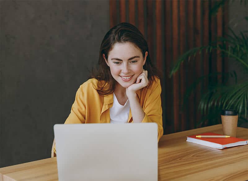 Girl Smiling on a Computer